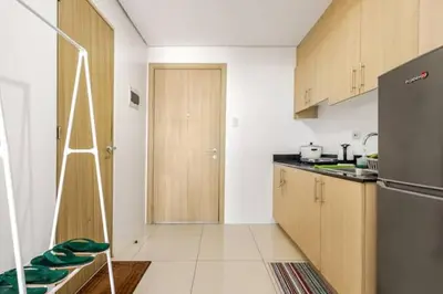 a kitchen with a refrigerator and a ladder in it at Sunrise & City View Steps from MOA & Bay Free WiFi in Manila
