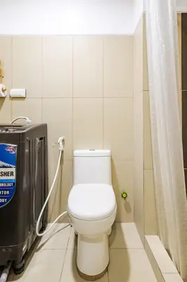 a bathroom with a white toilet in a stall at Sunrise & City View Steps from MOA & Bay Free WiFi in Manila