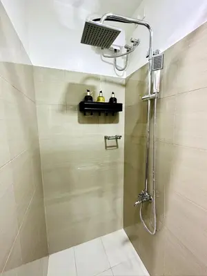 a bathroom with a shower with a shower head at CL10100 House in Manila