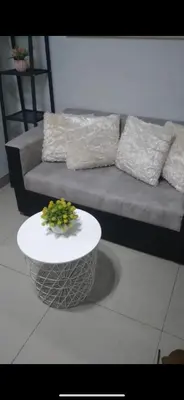 a living room with a couch and a table at Yuttari in Manila