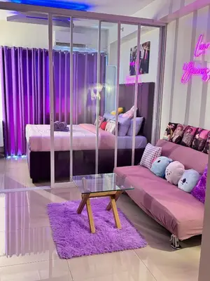 a living room with two beds and a glass table at BTS CRIB at MOA PASAY CITY in Manila
