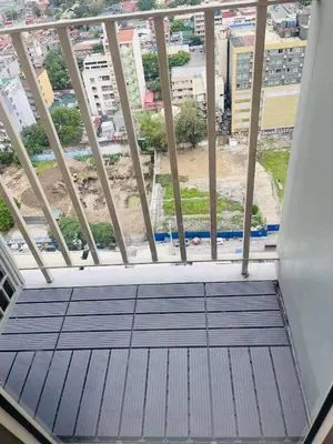 a balcony with a view of a city at JCS Place in Manila