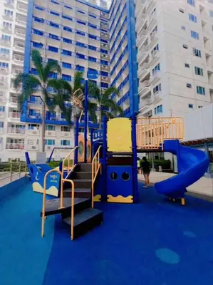 a playground with a slide on a blue floor at Sea Residences Mall of Asia- Jerson in Manila