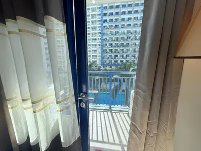a room with a window with a view of a building at Sea Residences Mall of Asia- Jerson in Manila