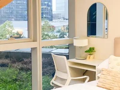 a bedroom with a desk and a chair and a window at Stylish BGC Condo by Grand Hyatt #upt16k in Manila