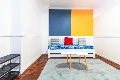 a living room with a couch and a table at Stylish Hip studio in the Heart of Poblacion, in Manila