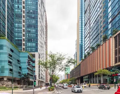 a street in a city with tall buildings at Stylish condo in BGC near Uptown mall and St Lukes in Manila