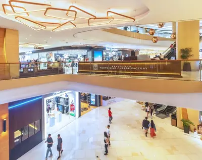 a group of people walking through a shopping mall at Stylish condo in BGC near Uptown mall and St Lukes in Manila