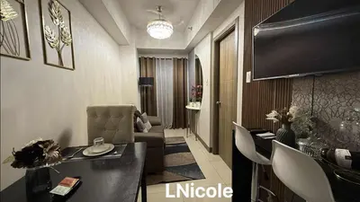 a living room with a couch and a television at LNicoles Pad in Manila