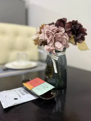 a vase with flowers in it on a table at LNicoles Pad in Manila