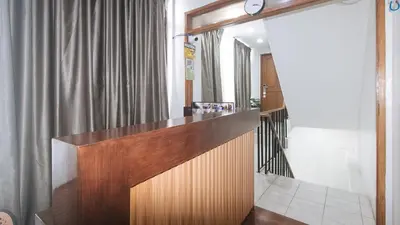a reception desk in a room with a curtain at GREN PLACE near Baclaran Airport Road by RedDoorz in Manila