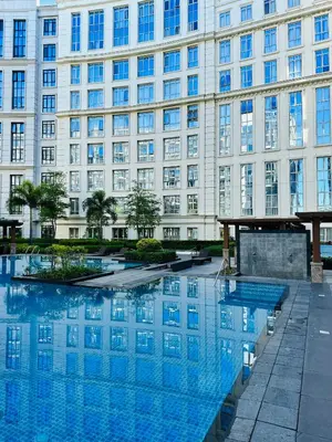 a large building with a pool in front of it at 81 Newport Blvd Cluster 5 Unit 3F by Rechelle Nunag in Manila