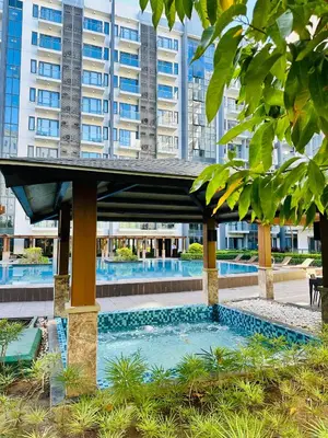 a swimming pool in front of a building at 81 Newport Blvd Cluster 5 Unit 3F by Rechelle Nunag in Manila