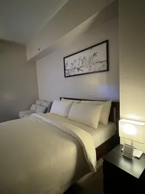 a bedroom with a bed and a picture on the wall at 81 Newport Blvd Cluster 5 Unit 3F by Rechelle Nunag in Manila