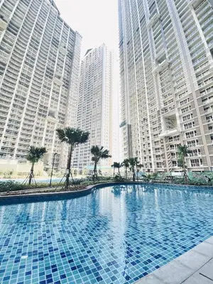 a large swimming pool in a city with tall buildings at JFam Suites Allegra Condo with Balcony, FREE Parking in Manila