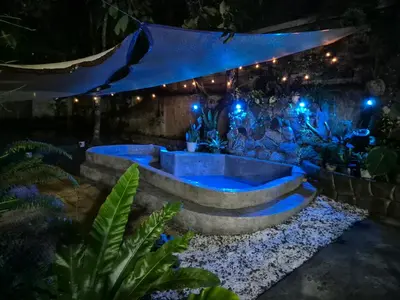 a hot tub in a garden at night at Sotera and Paz Forestville in Silang