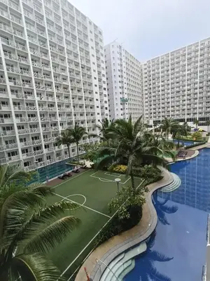 an aerial view of a large apartment complex with palm trees at Shore residences tower D by Ben in Manila