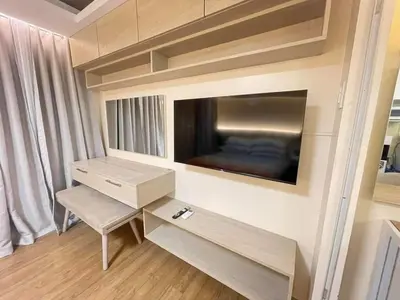 a living room with a flat screen tv on a wall at 1 BR Nordic Suite with Netflix, Disney, Prime in Manila