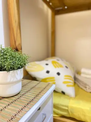 a bedroom with a pillow and a potted plant on a table at The Cozy Cove - 3BR with Netflix, Prime and KTV in Manila