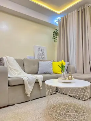 a living room with a couch and a table at The Cozy Cove - 3BR with Netflix, Prime and KTV in Manila