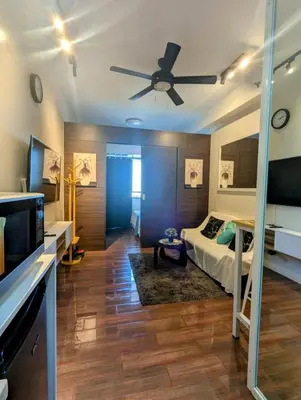 a bedroom with a bed and a ceiling fan at d'DEN at SMDC AIR Makati 1BR Bay view in Manila