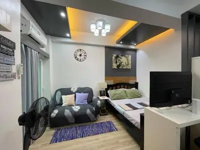 a small bedroom with a bed and a couch at 19f w NFLIX & BALCONY NEAR ROB, PGH, ACC USM&SLMC in Manila