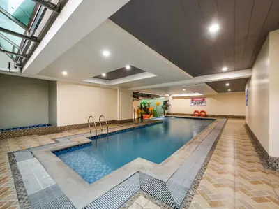 a swimming pool in a hotel room with a swimming pool at 19f w NFLIX & BALCONY NEAR ROB, PGH, ACC USM&SLMC in Manila