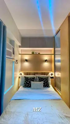a bedroom with a large bed with lights on it at MODERN ZEN Den in Manila