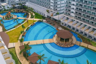 an overhead view of a swimming pool at a resort at Newly Renovated Shell Residences Mall of Asia Condo in Manila