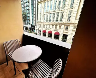 a table and chairs in a room with a window at Hestia Homes near Airport in Manila