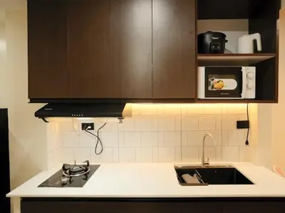 a kitchen with a sink and a microwave at Cozy Crib2 in Manila