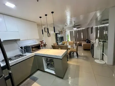 a large kitchen and living room with a dining room at Kathys Crib 2Bedroom MOA View at Shell Residence in Manila