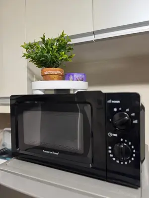 a black microwave with a plant on top of it at 81 Newport Boulevard Condominium across International Airport Terminal 3 C1-4C in Manila