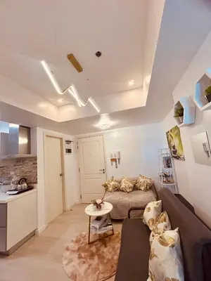 a living room with a couch and a table at 2br in Azure with Manila Bay View & Laguna de Bay View in Manila