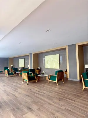 a waiting room with chairs and tables in a hospital at MAKATI - Lush Residences in Manila