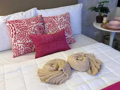 a bed with two towels on it with pillows at Shore Residences Sunset Room facing Manila Bay & City View RM1641 by Prime Stay MOA in Manila