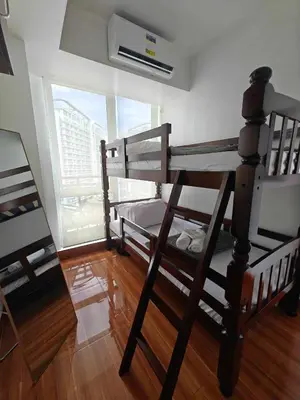 two bunk beds in a room with a window at Serenity Escapes by Aj in Manila
