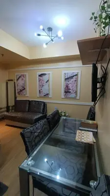 a living room with a couch and a fish tank at Joy Azure Escapes in Manila
