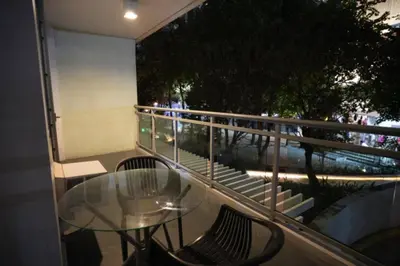a glass table and chairs on a balcony at Joy Azure Escapes in Manila
