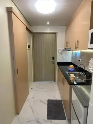 a kitchen with a marble floor and a sink at Fairy Dust Sky Suite By Crib2GO in Manila