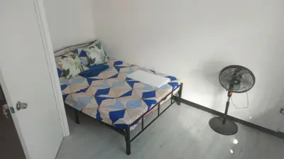 a bedroom with a bed and a fan at Affordable accommodation near NAIA, MOA and BGC in Manila