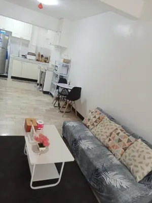 a living room with a couch and a table at Affordable accommodation near NAIA, MOA and BGC in Manila