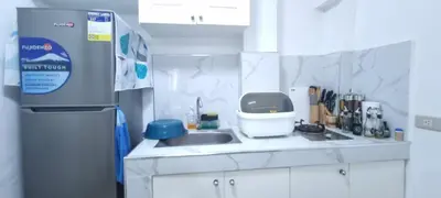 a small kitchen with a sink and a mixer at Affordable accommodation near NAIA, MOA and BGC in Manila