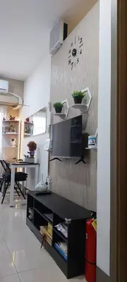 a living room with a clock on a wall at Fully Furnished 1 Bedroom Condo - Fame Residences, Tower 2 in Manila