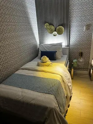 a bed with a yellow blanket on it in a bedroom at AZURE BICUTAN -MIAMI TOWER 6 Floor in Manila