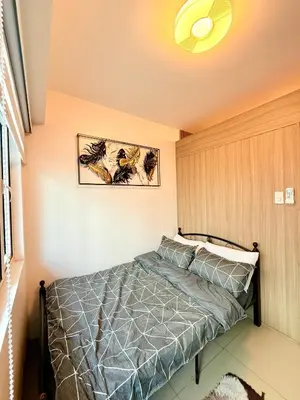 a bedroom with a bed and a ceiling at Modern Double-Sized Bed with Netflix & Pool View in Manila