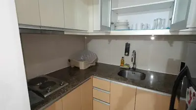 a kitchen with a sink and a counter top at 81 Newport Boulevard across Manila Airport NAIA T3 in Manila