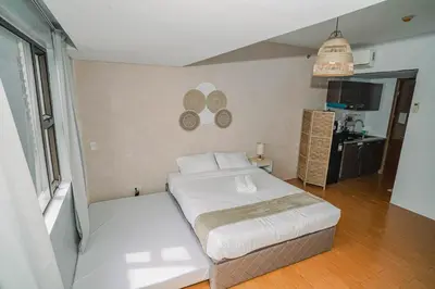 a bedroom with a large bed in a room at TahananStays at Makati CBD in Manila