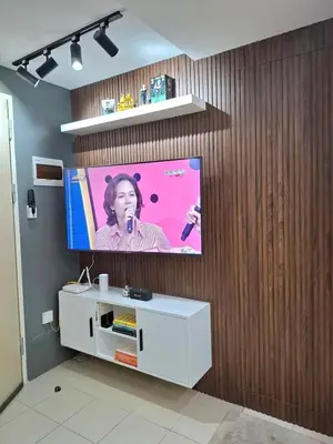 a flat screen tv hanging on a wooden wall at 1BR with Prime Netflix, Disney HBO max in Manila