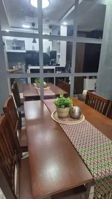 a wooden table with chairs and plants on it at 1BR with Prime Netflix, Disney HBO max in Manila